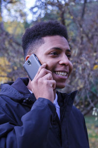 Smiling man talking on mobile phone