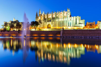 Reflection of illuminated buildings in lake