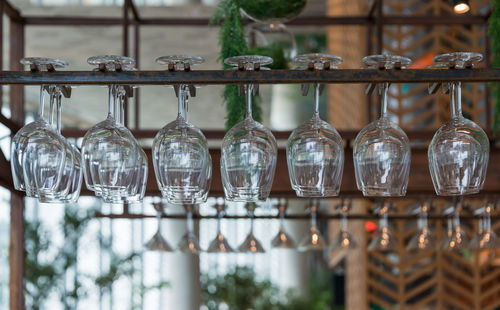 Close-up of glass bottles hanging on table