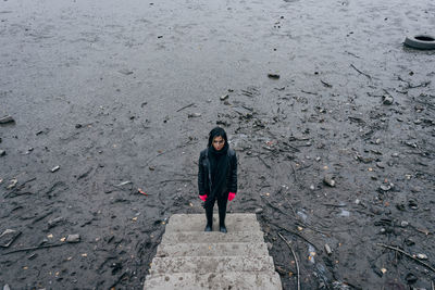 High angle view of woman standing at steps