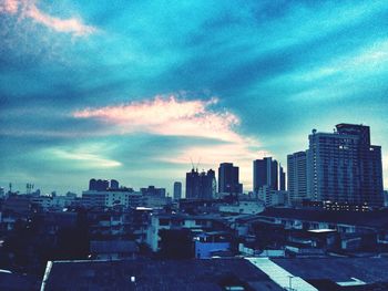 City buildings against cloudy sky