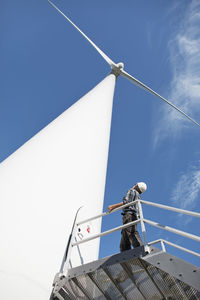 Engineer in front of wind turbine