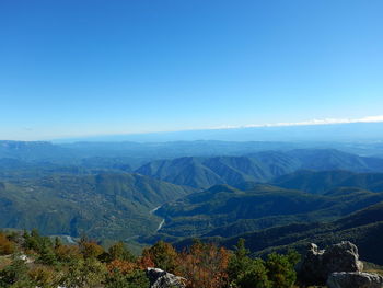 Scenic view of mountains against clear blue sky