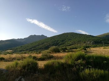 Scenic view of mountains against cloudy sky