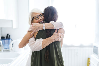 Couple kissing in front of woman