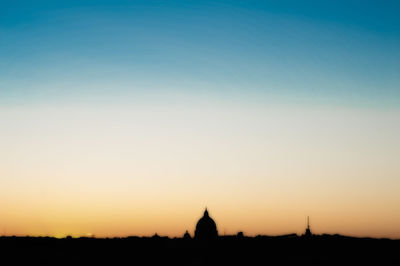 Silhouette temple against clear sky during sunset