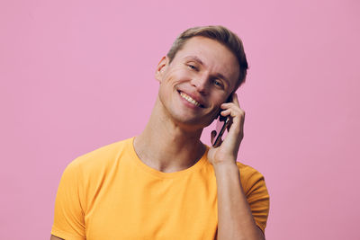 Young man looking away against white background