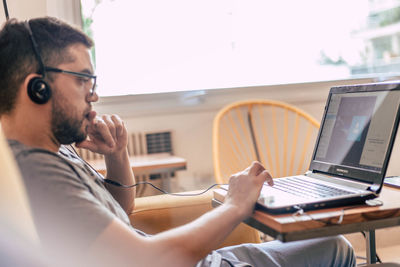 Young man using laptop at home