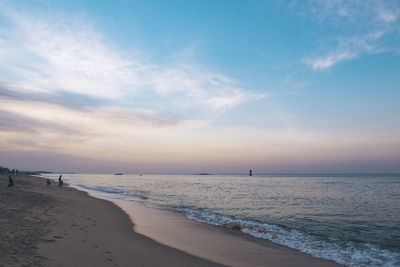 Scenic view of beach against sky during sunset