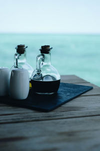 Close-up of coffee on table by sea