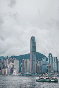 View of modern buildings against cloudy sky