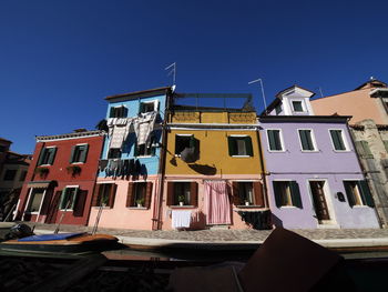 Low angle view of buildings against blue sky