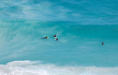 People surfing in sea