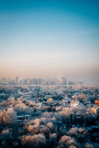 Aerial view of cityscape against clear sky during sunset