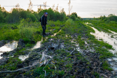 Man standing by plants on land