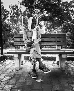 Man sitting on bench in park