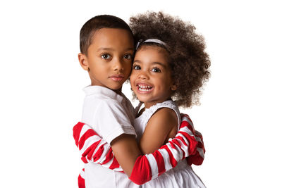 Portrait of smiling boy against white background