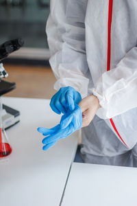 Rear view of man working on white wall