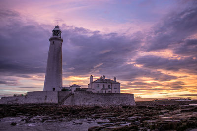 Low angle view of lighthouse against sky during sunset