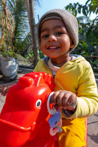 Portrait of smiling boy holding camera