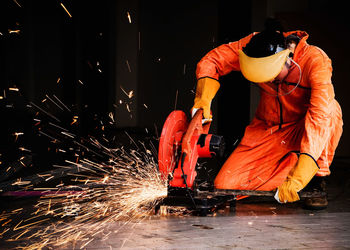 Worker welding metal in workshop