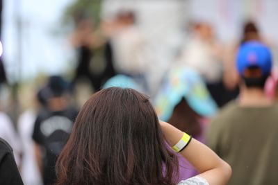 Rear view of women against blurred background