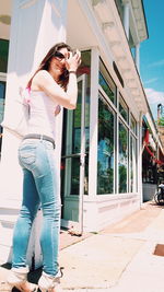 Portrait of woman standing by building