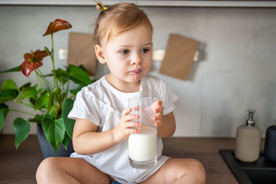 Portrait of cute baby boy sitting at home