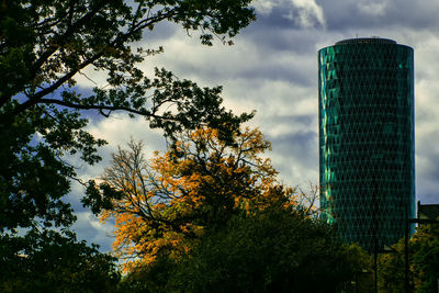 Low angle view of trees and buildings against sky