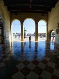 People walking in corridor of building