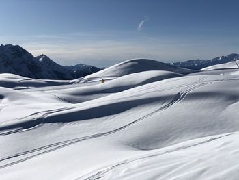 Scenic view of snow covered mountains against sky