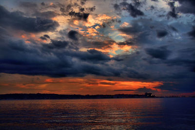 Scenic view of dramatic sky over sea during sunset