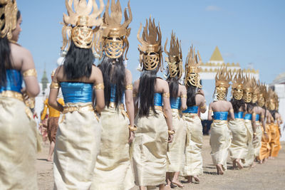 Rear view of women walking on street during traditional festival