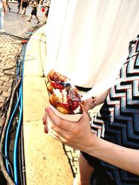 Midsection of woman holding ice cream