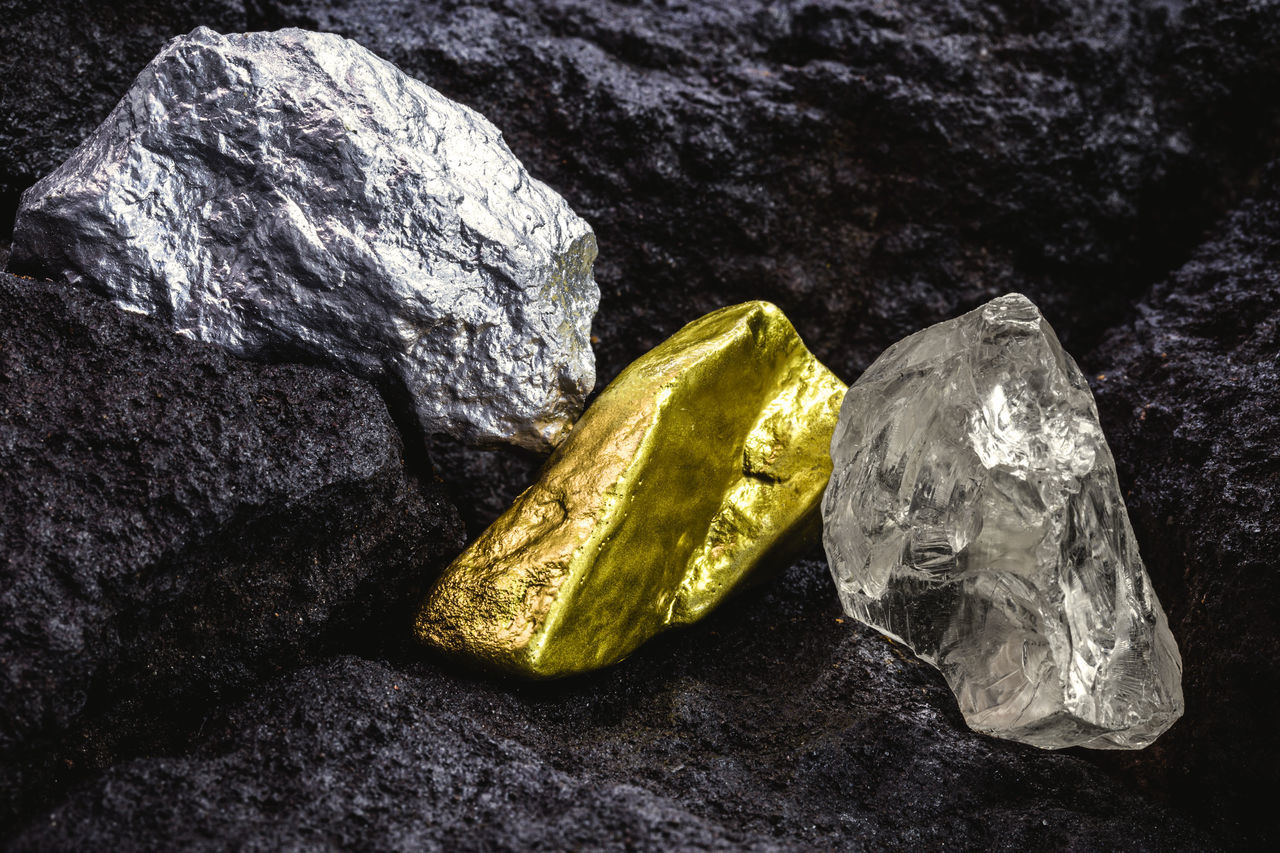 CLOSE-UP OF ROCKS ON ROCK AGAINST GREEN BACKGROUND