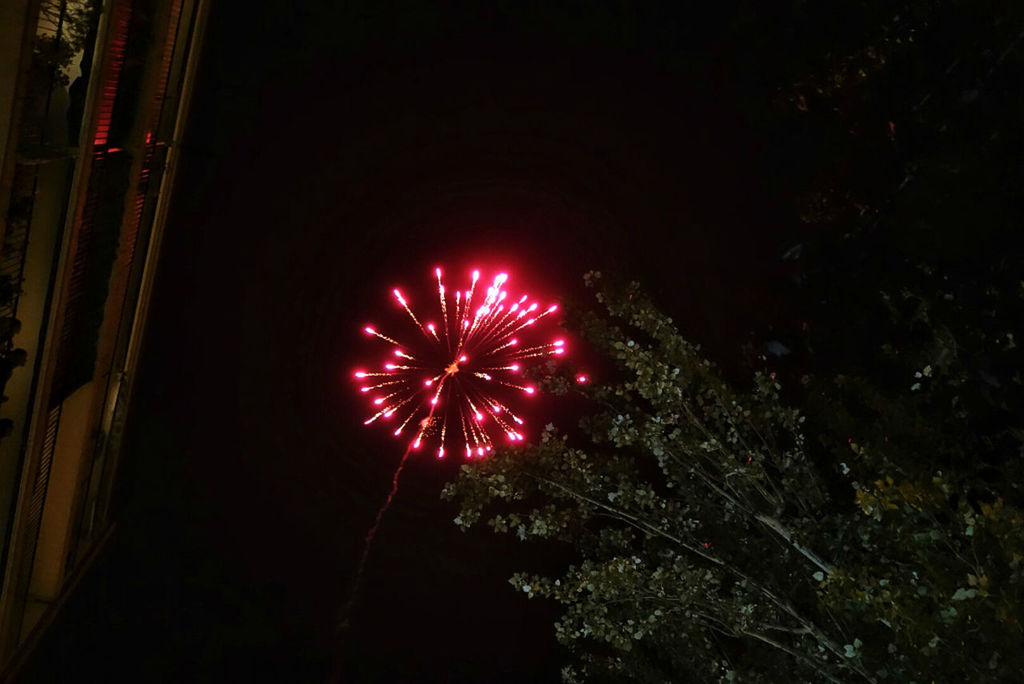 night, illuminated, low angle view, celebration, red, lighting equipment, multi colored, glowing, decoration, outdoors, architecture, built structure, no people, sky, arts culture and entertainment, firework display, building exterior, christmas, dark, celebration event