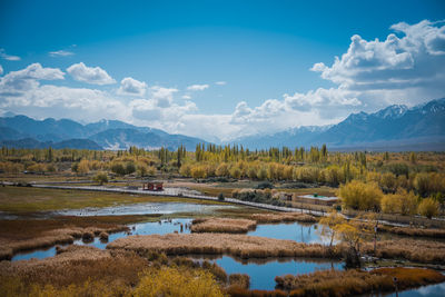Scenic view of lake and mountains against sky