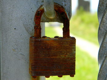 Close-up of padlock on rusty metal