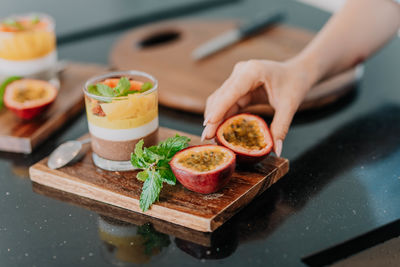 Cropped hand of woman having food on table