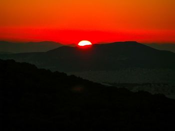 Scenic view of silhouette mountains against sky at sunset