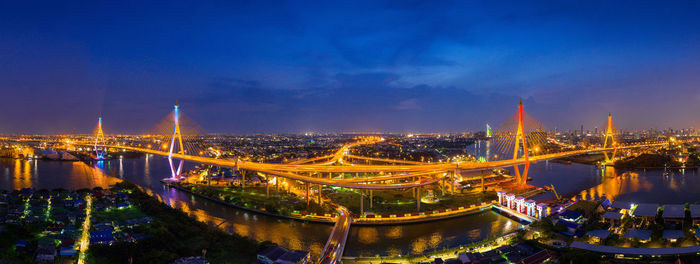 Illuminated bridge and buildings at night