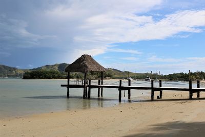 Built structure on beach against sky