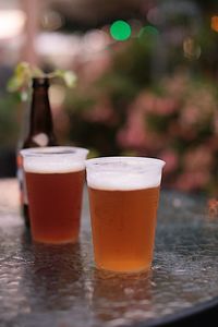 Close-up of beer glasses on table