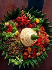 Tumpeng rice in a bamboo woven tray.