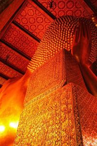 Low angle view of statue against illuminated building