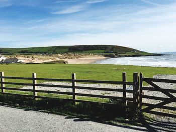 Scenic view of landscape and sea against sky