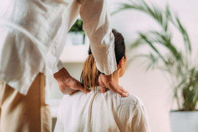 Woman enjoying shiatsu back massage, sitting on the shiatsu massage mat.