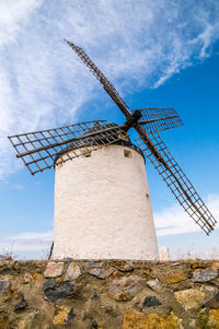 Low angle view of traditional windmill against sky