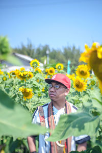 Portrait of woman standing by plants