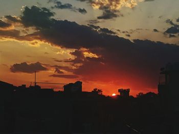 Silhouette buildings against sky during sunset